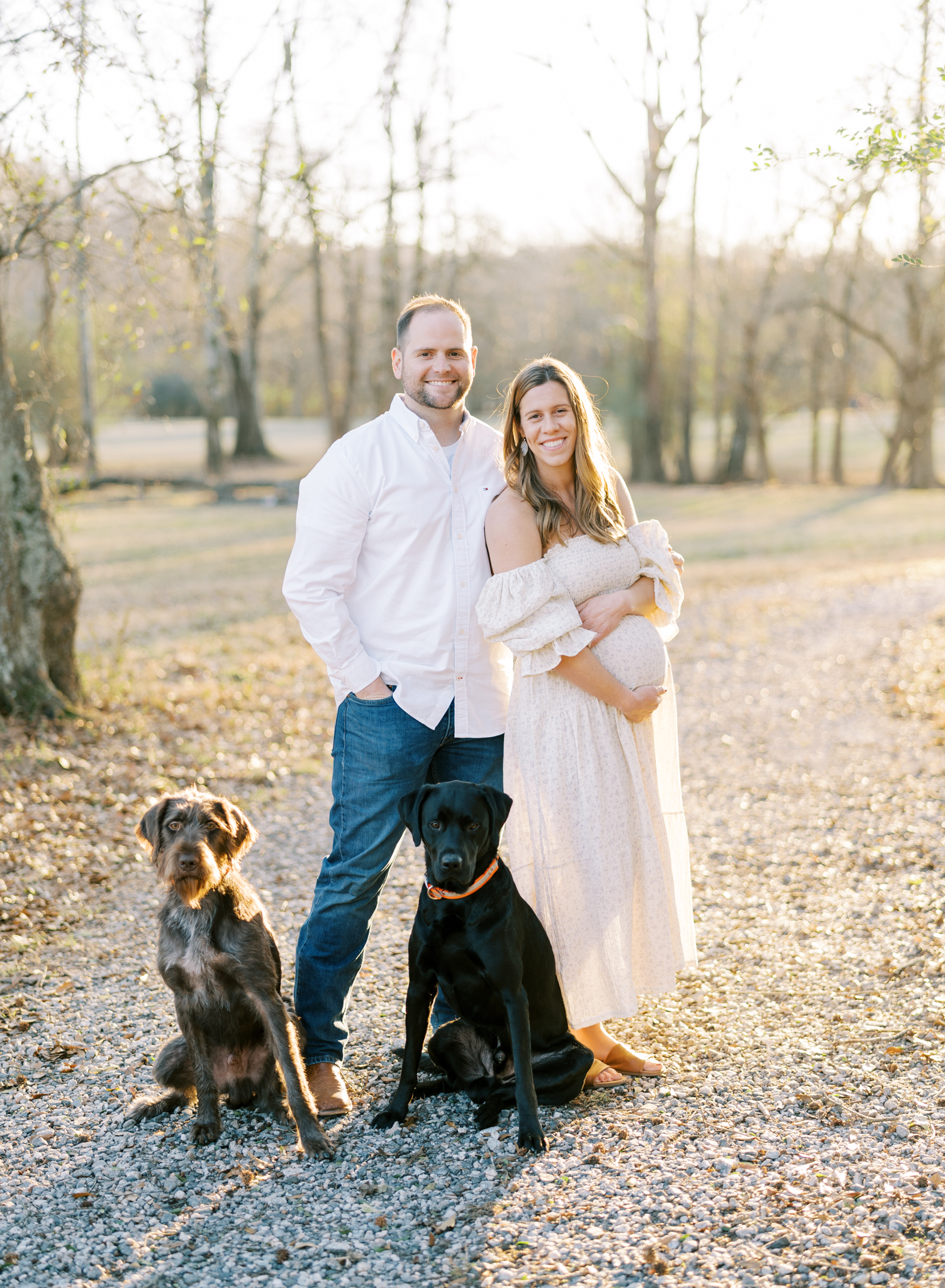 Expectnat coule with their dogs in Cumming, GA maternity photoshoot
