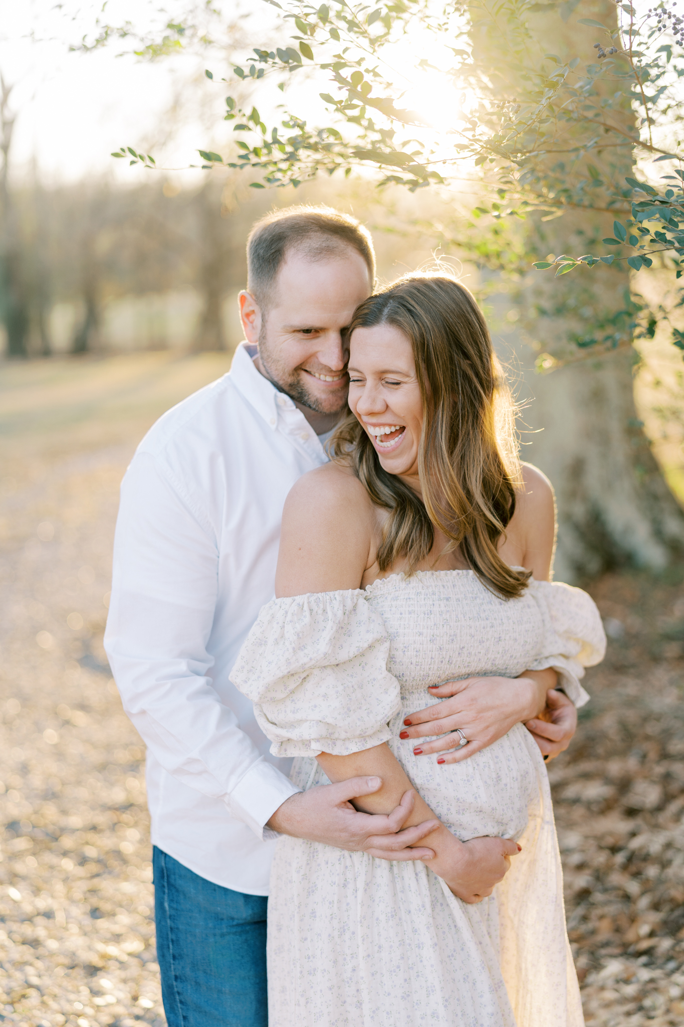 Laughing expectant parents during maternity photoshoot in Cumming GA