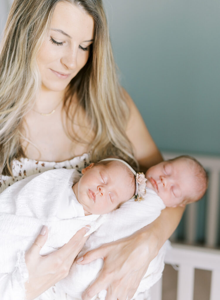 newborn bother and sister twins in moms arms.