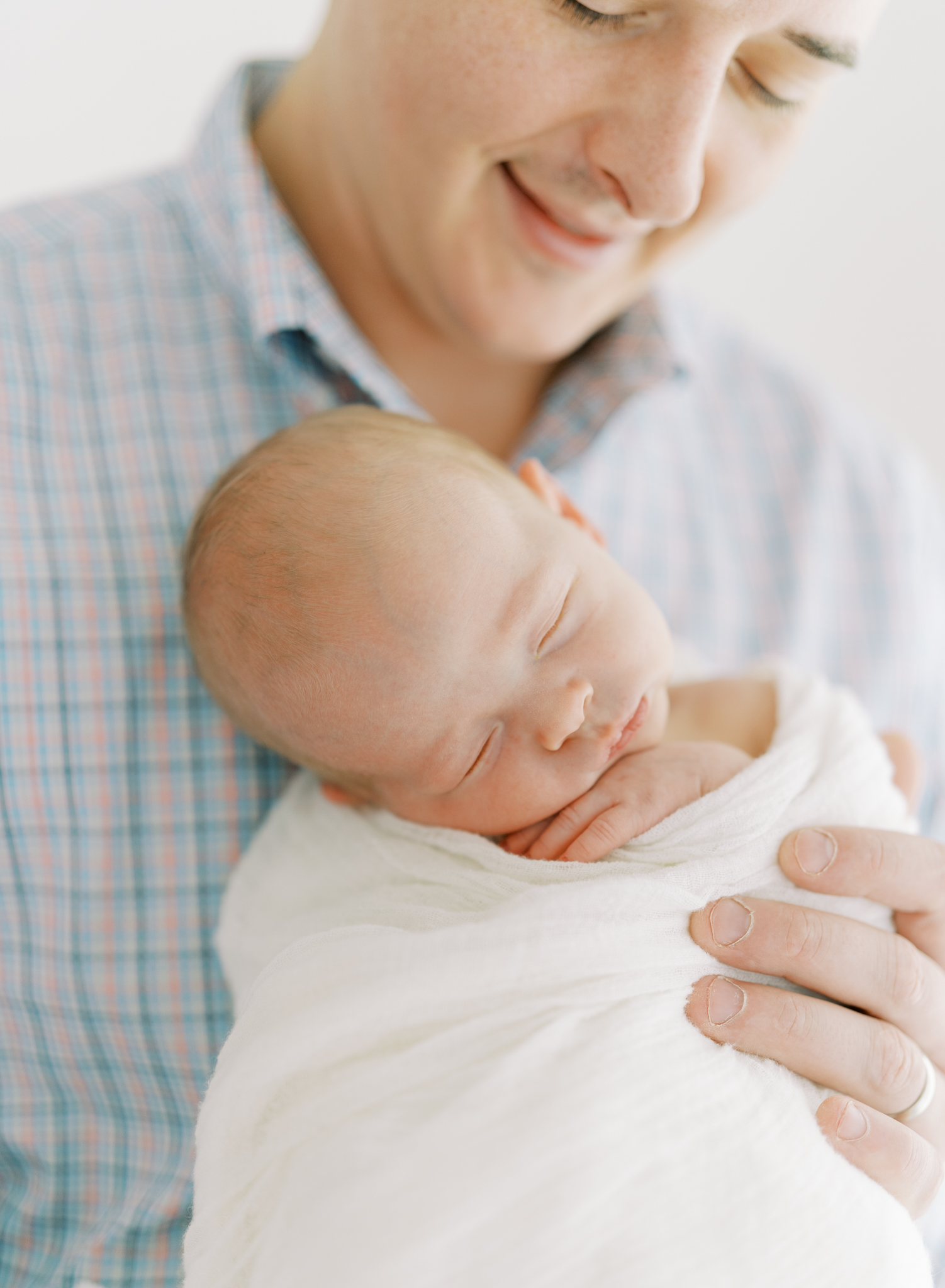 tiny baby boy on dad's chest