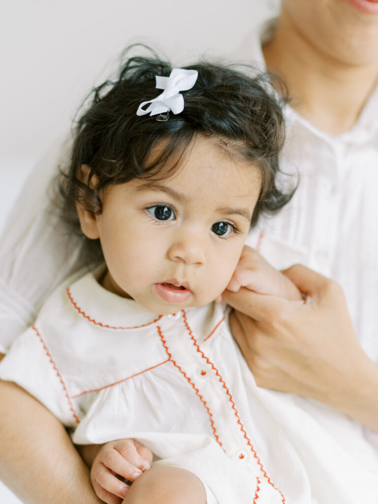 Mom snuggling up her 6 month baby girl in Atlanta, GA photography studio.