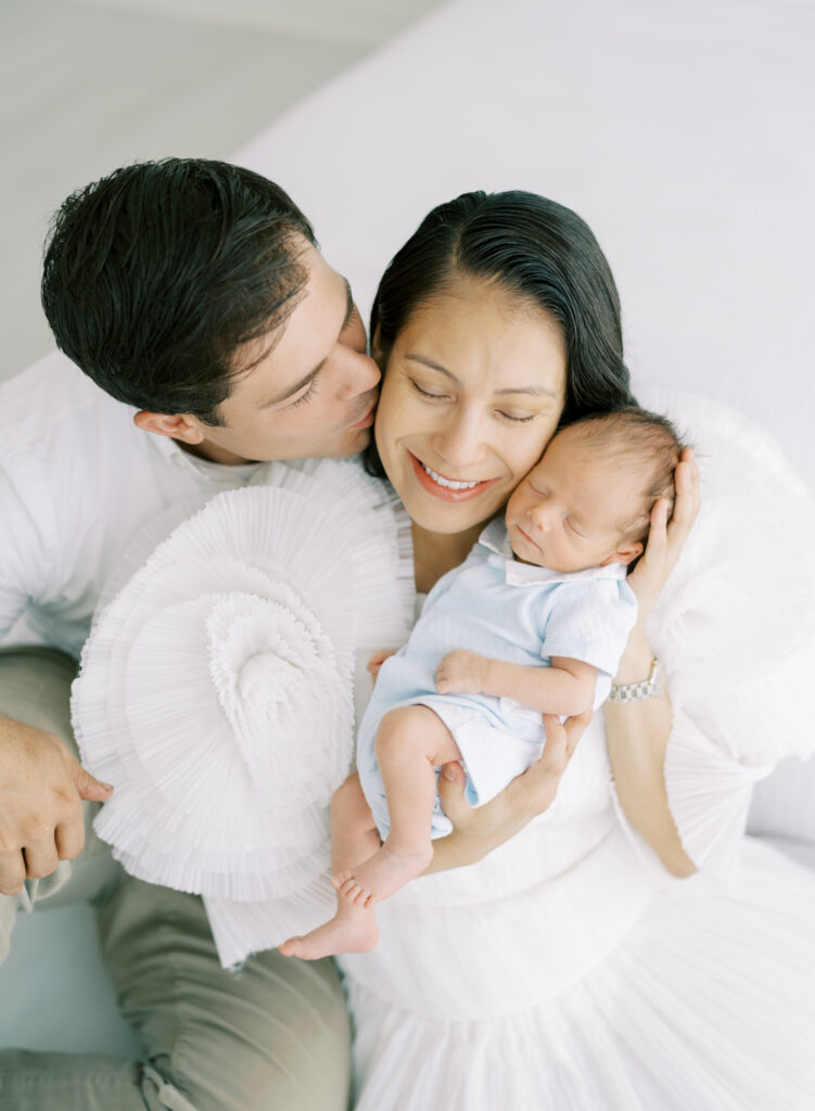 New parents posing for natural newborn photos in Cumming, GA.