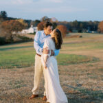 Natural maternity photography in a field with husband in Cumming, GA