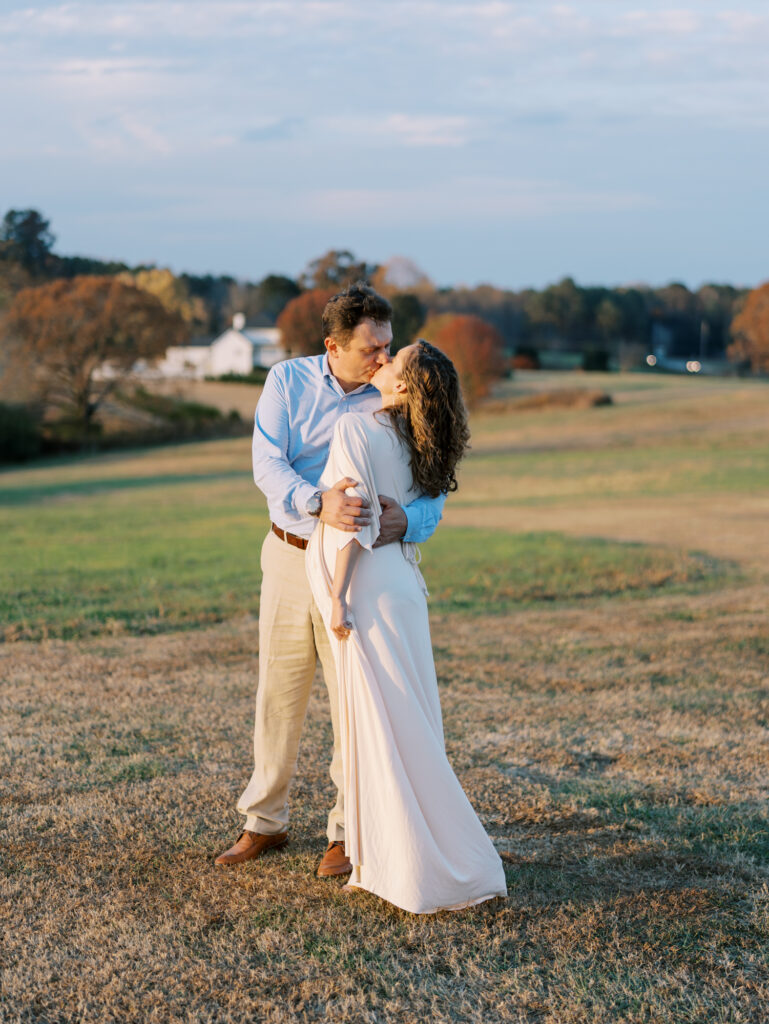 Natural maternity photography in a field with husband in Cumming, GA