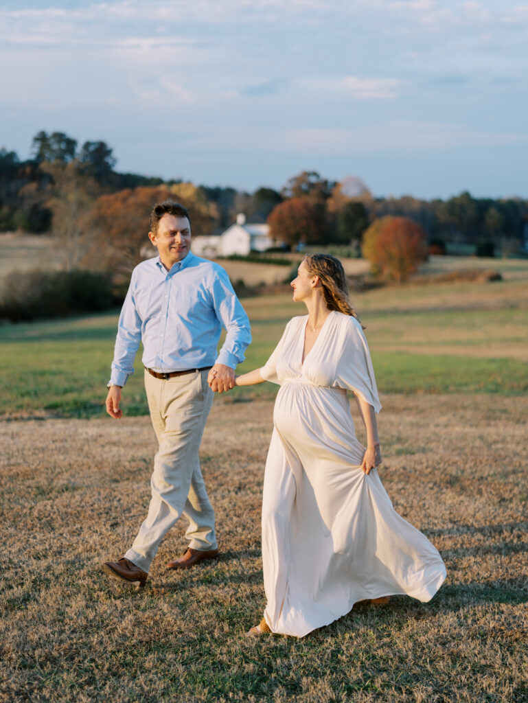 Natural maternity photography in a field with husband in Cumming, GA